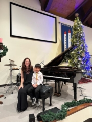 Before performing, young students observe a recital first.